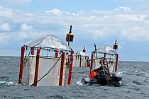 The mesocosm systems developed in Kiel at the Baltic Sea at Booknis Eck. Photo: U. Riebesell, IFM-GEOMAR