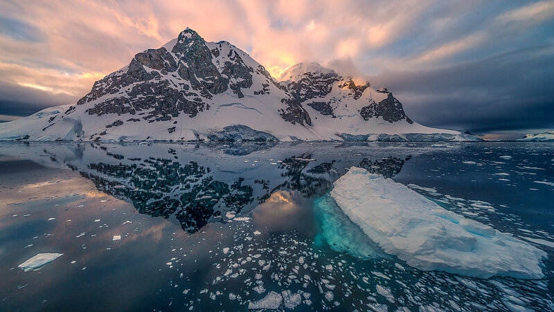 An iceberg and ice floes floating on the sea