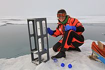 Luisa Galgani vor einem Schmelzwassertümpel mit Spezialvorrichtungt zur Beprobung der Wasseroberfläche. Foto: Karl Attard