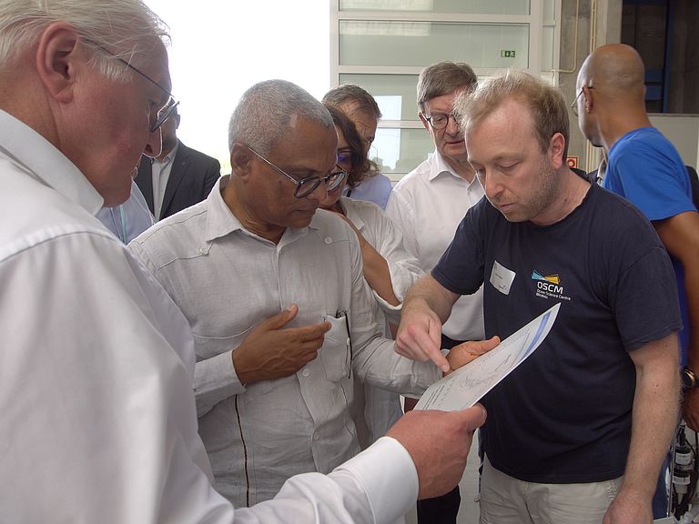 Bundespräsident Frank-Walter Steinmeier und José Maria Neves, Präsident der Republik Cabo Verde, mit Björn Fiedler, Wissenschaftlicher Koordinator des OSCM.
