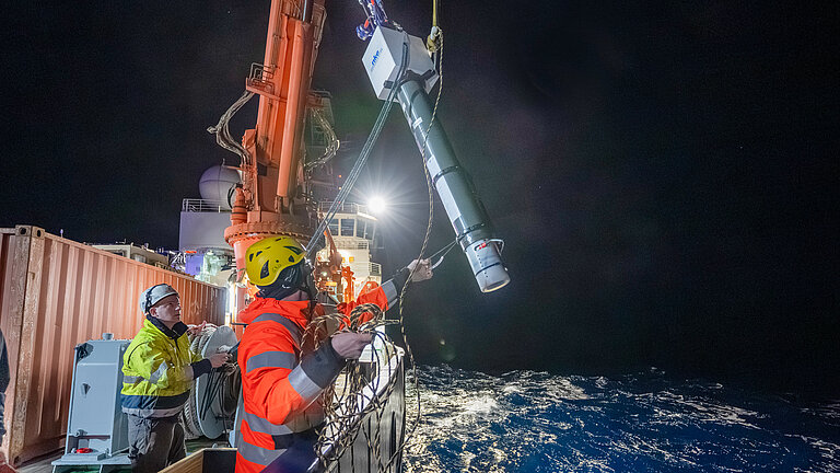 A measuring buoy is being hauled aboard the research vessel