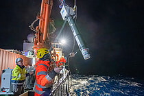 A measuring buoy is being hauled aboard the research vessel