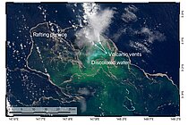 Satellite image of the sea surface; the water is dark blue but has a green tinge in places, and a white cloud of vapour is rising from the water