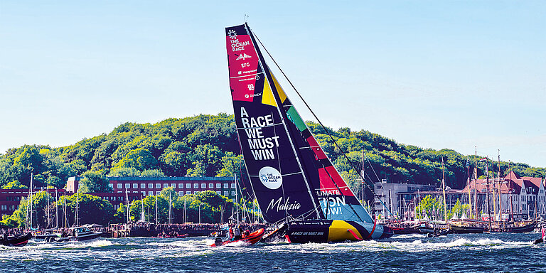 racing yacht in front of the city skyline