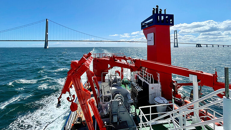 RV Alkor in front of the Great Belt Bridge in Denmark. 
