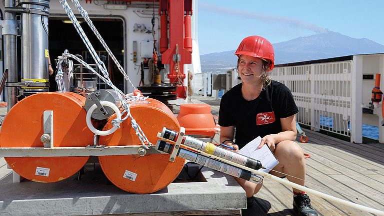 Prof. Dr. Morelia Urlaub checks a geodesy station for measuring seafloor movements at Etna during expedition SO277.