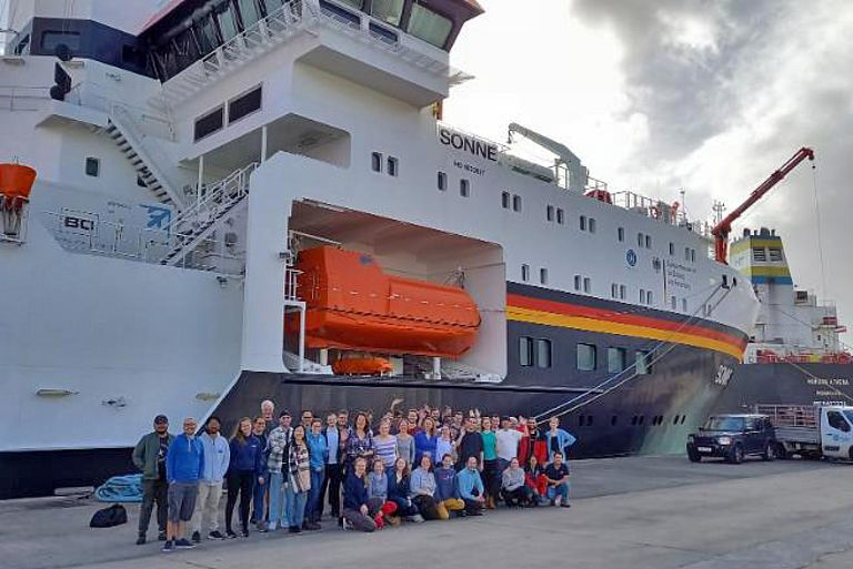 Researchers in front of research vessel SONNE.