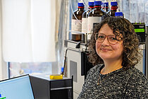 Young woman with dark curls in a laboratory