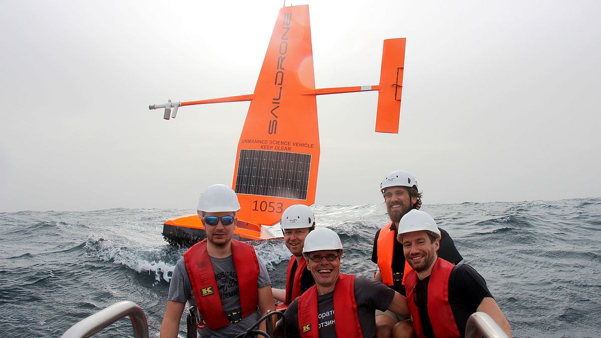 Group of Scientists in front of Saildrones