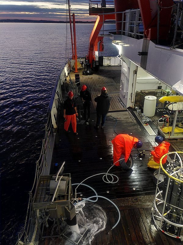 Figure 8: Water sampling and sediment sampling during night time to gather reference material. (Photo: Tim Weiß)