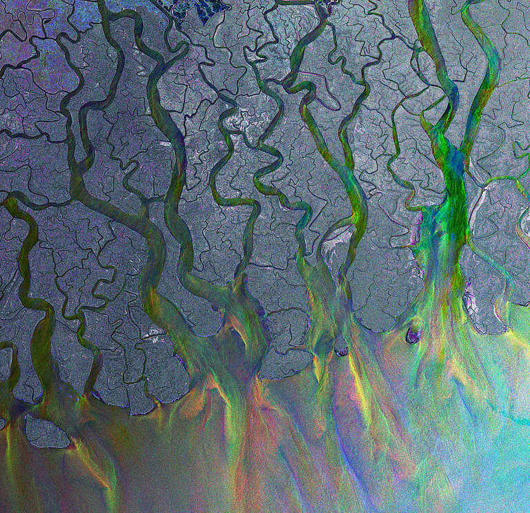 View from space of glistening rivers flowing into the sea