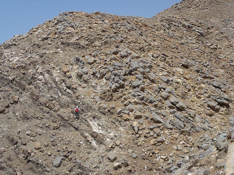 The thick limestones of the Morro formation are intruded by volcanic dykes. Person for scale. Photo: Lisa Samrock