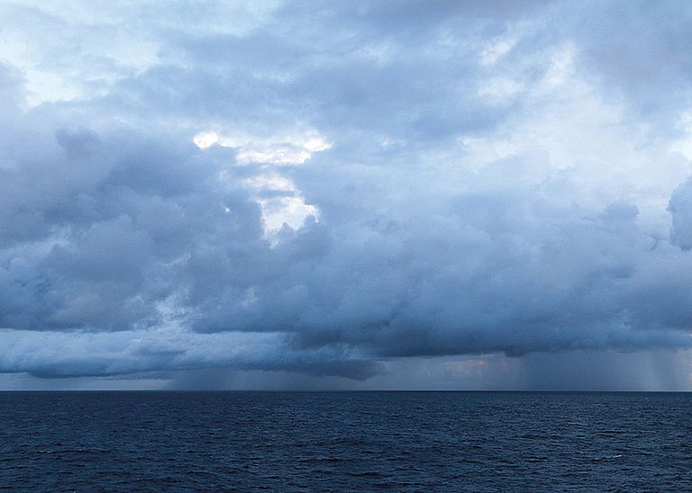 Dunkle Wolken am Horizont kündigen einen Wirbelsturm an. Dieses Wetterphänomen wird im Indischen Ozean und Südwestpazifik als Zyklon bezeichnet.