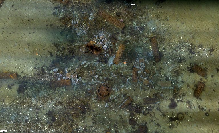 Photo mosaic with old munitions on the sea floor,