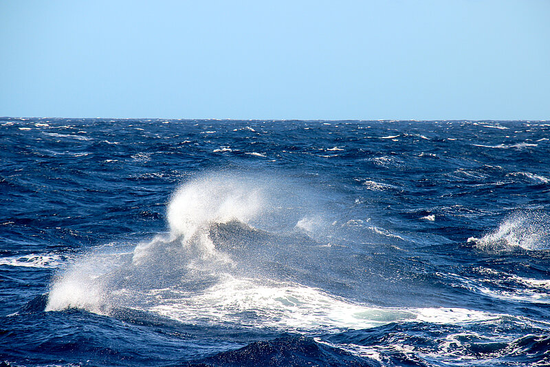 Wave. It has white foam. On the sea.