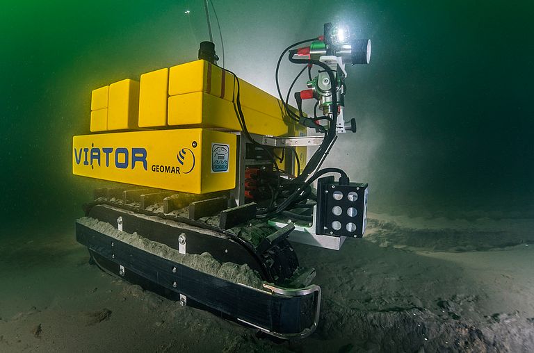 Yellow submarine vehicle on the seafloor, with the name VIATOR.