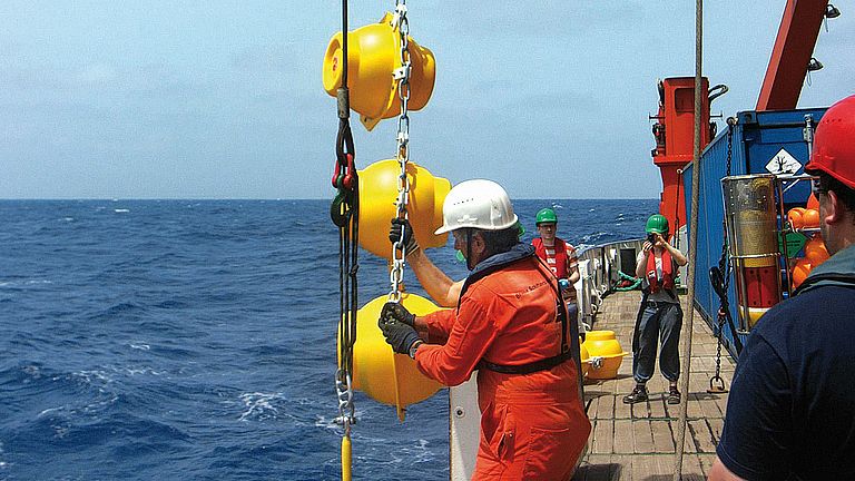 The crew of RV METEOR deploys an ­oceanographic mooring at the Cape Verde Ocean Observatory. 