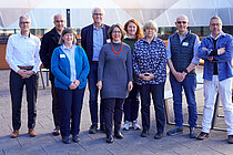 A group of people on a roof terrace, four women and five men