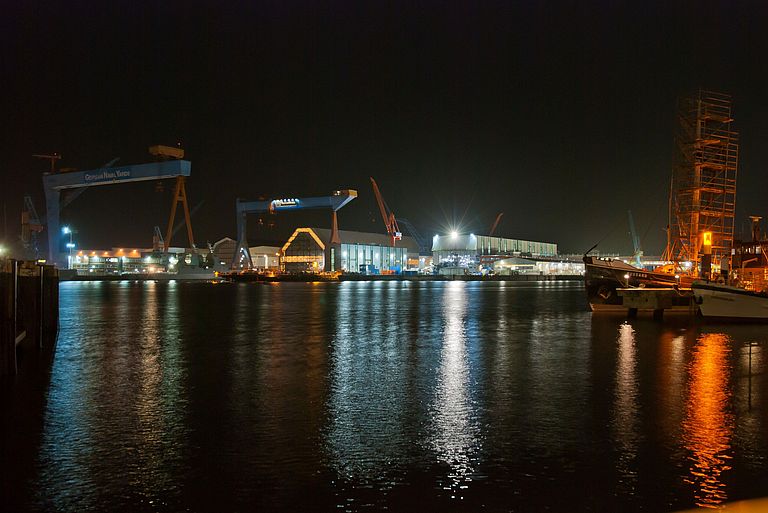 View over the Kiel Inner Fjord at night. Numerous lamps illuminate the water.