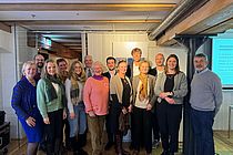 A group of people smiling into the camera