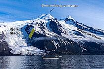 A picture of snow-capped mountains right by the sea; in two places, the ice reaches right down to the coast – these are the two glaciers.