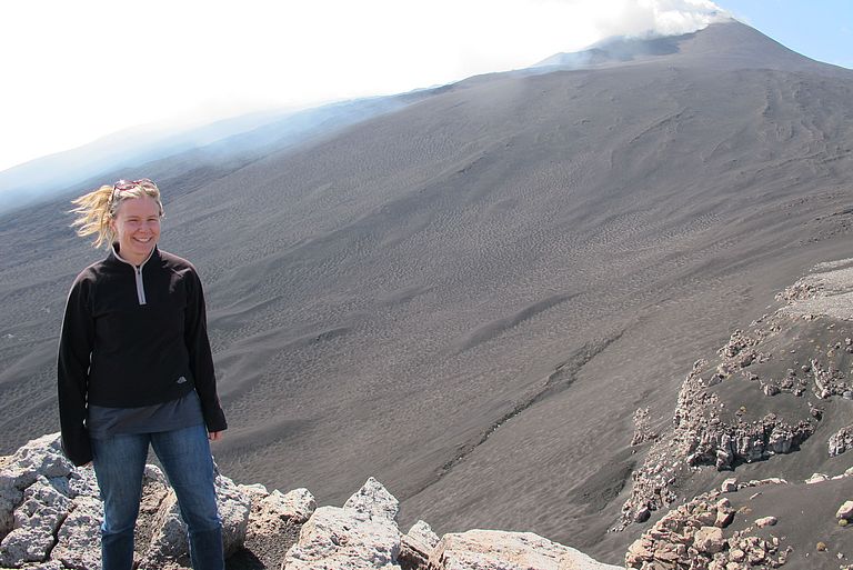 Dr. Morelia Urlaub standing on Mount Etna.