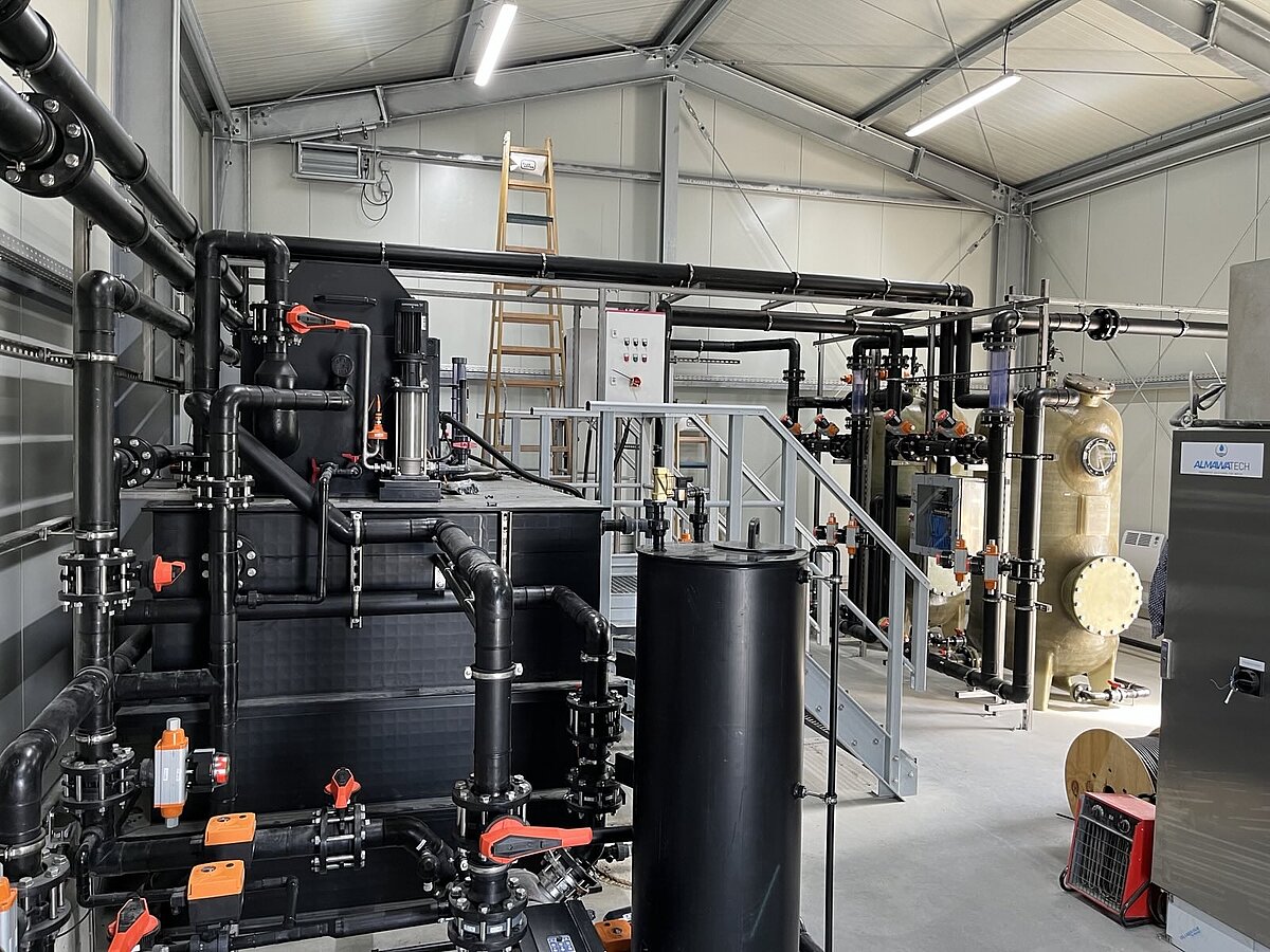 Various tanks and containers in a building are connected by tubes 