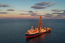  A drill ship on the sea in the evening sun