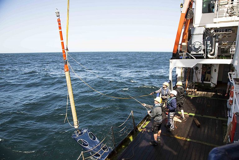 A drifter is deployed back to the water. A focus of this trip is on the drifter, a measuring device, which tracks the course of an upwelled water patch of deep water. Photo: Lisa Hoffmann (CC BY 4.0)