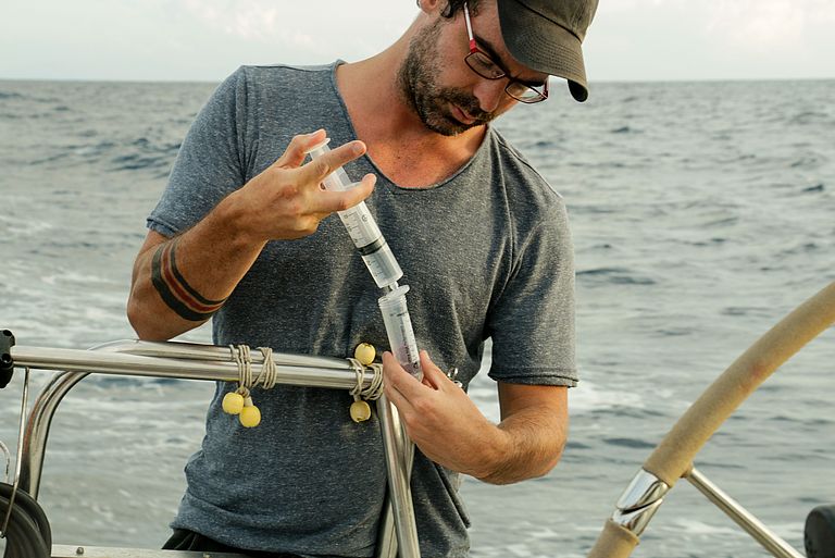 The lead author of the study, Dr. Mario Lebrato, taking seawater samples in a sailing cross-ocean expedition onboard “Delfin Blanco” from Menorca to Sardinia, in the Mediterranean Sea.