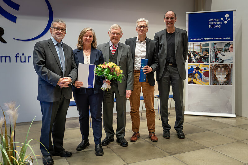 A group of four men and a women