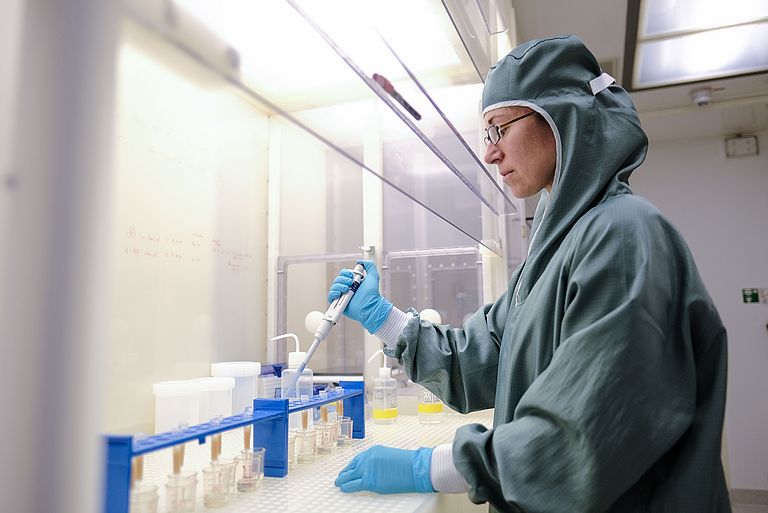 Scientist in green coat in a clean room laboratory of GEOMAR